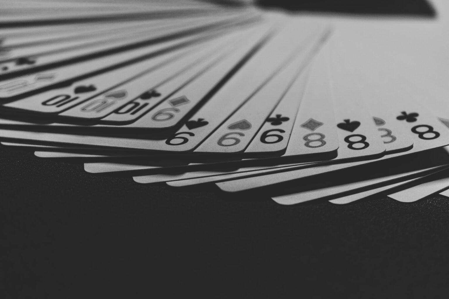 grayscale photo of a fanned playing card